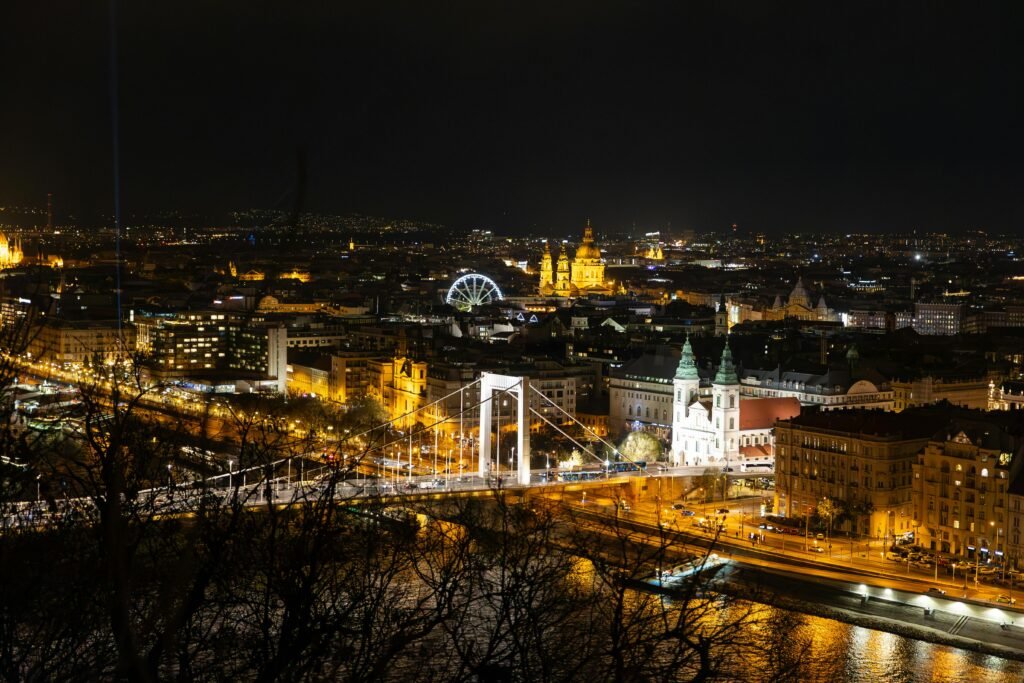 A stunning nighttime view of Budapest featuring the illuminated Elizabeth Bridge and St. Stephen's Basilica.