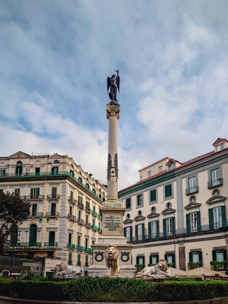 Stunning monument against historic buildings in a Naples piazza, Italy.